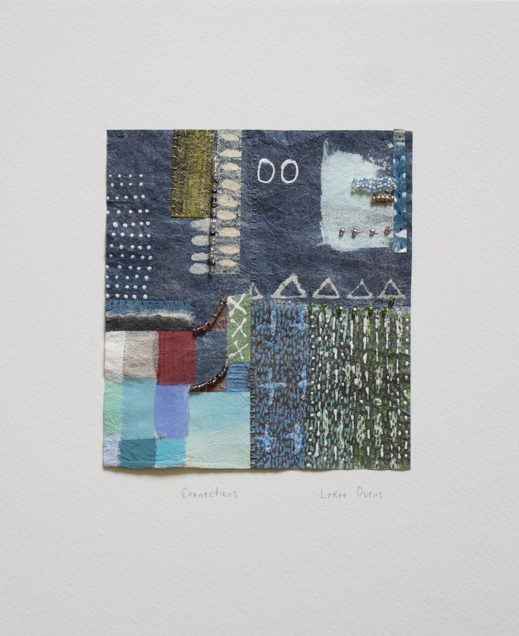 Connections by Loree Ovens: a small indigo patchwork with stitched dots and pale blue squares